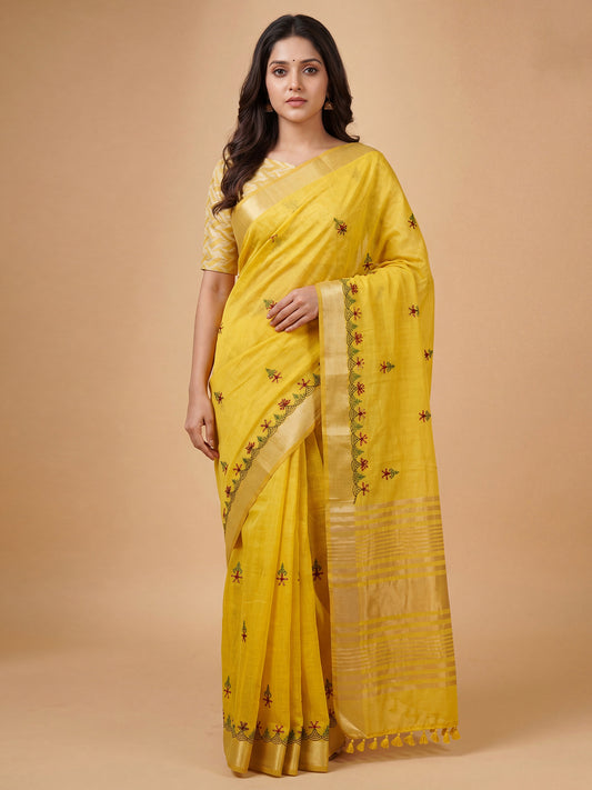 Woman wearing yellow cotton linen saree with embroidered motif work and yellow blouse