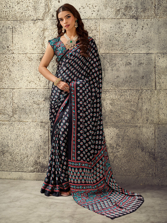 Woman wearing black satin saree with ajrak block-print motif work and teal blue blouse