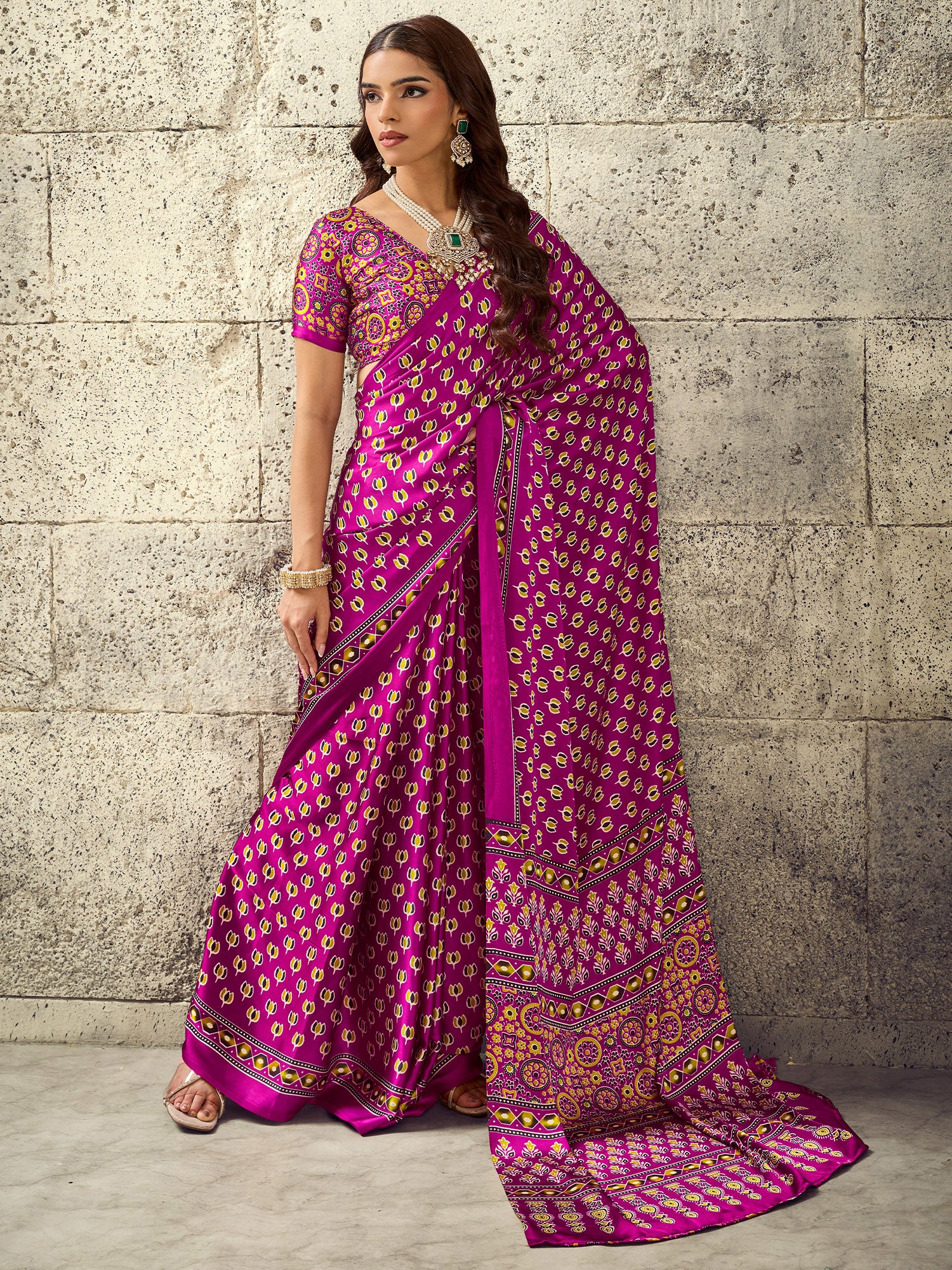 Woman wearing magenta satin saree with ajrak block-print motif work and magenta blouse