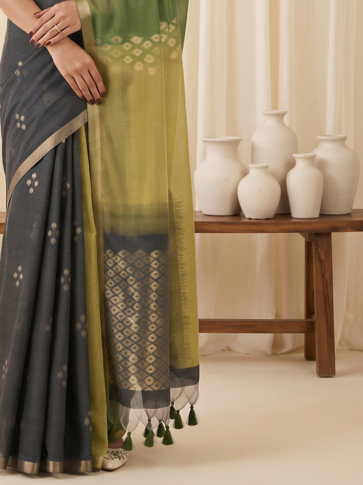 Pallu detail of green viscose silk saree showing traditional indian motif work and solid border