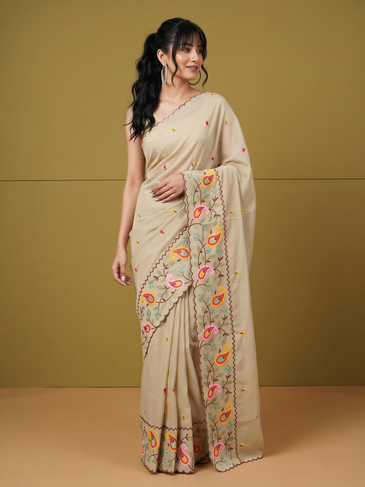 Woman wearing beige georgette saree with embroidered motif work and beige blouse