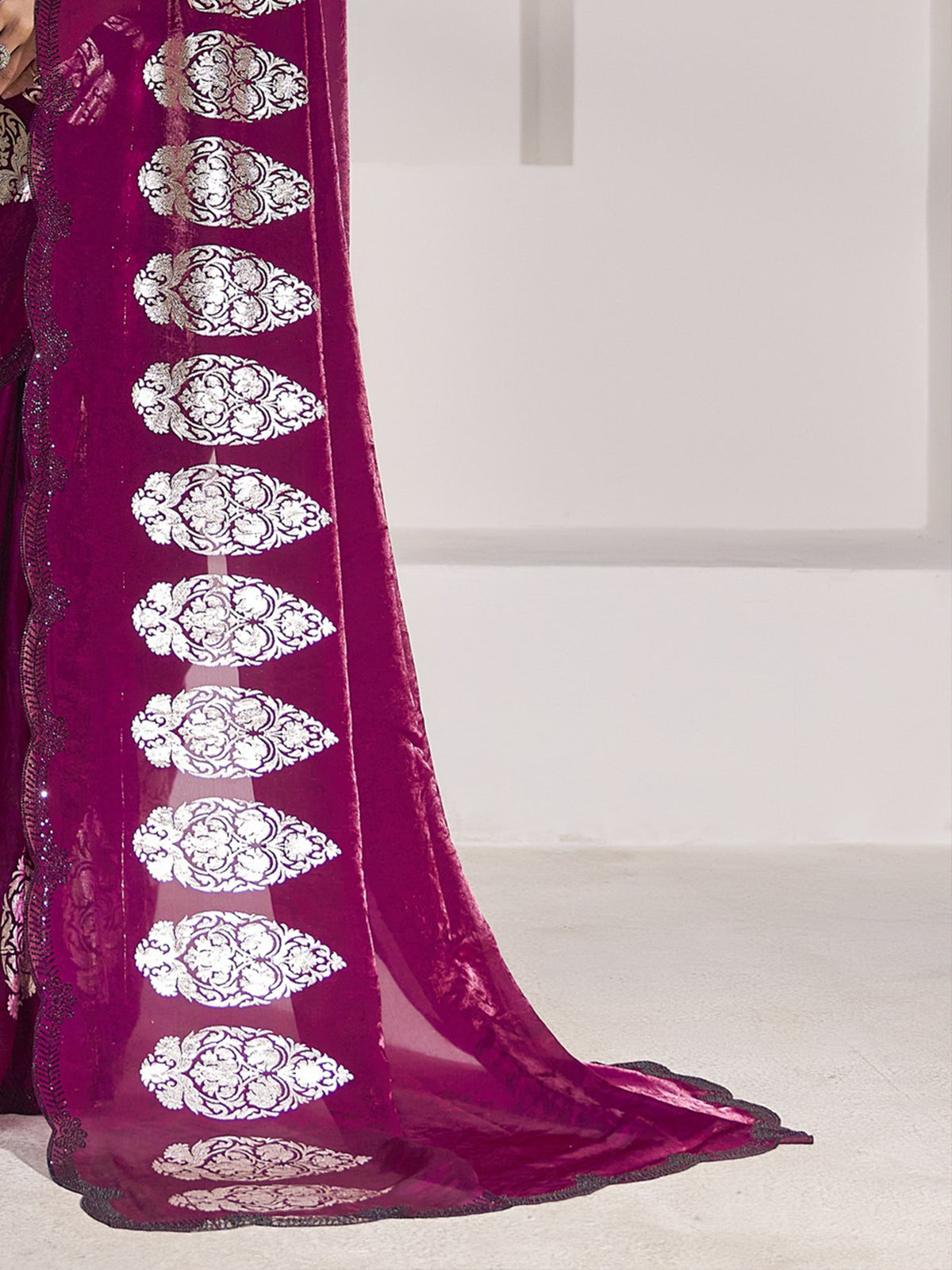 Pallu detail of magenta satin silk saree showing metallic foil print work and embellished border