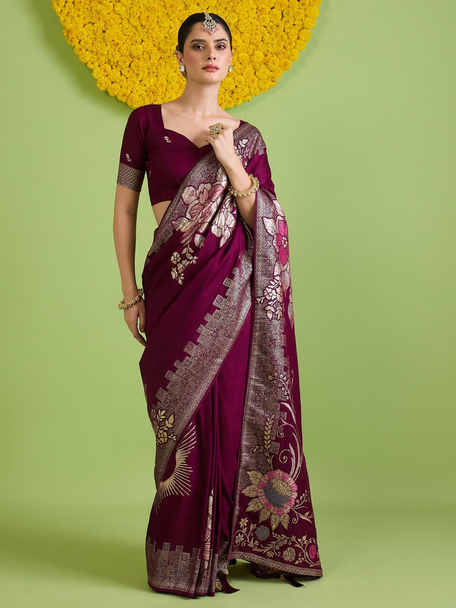 Woman wearing wine silk blend saree with all-over floral design and wine blouse