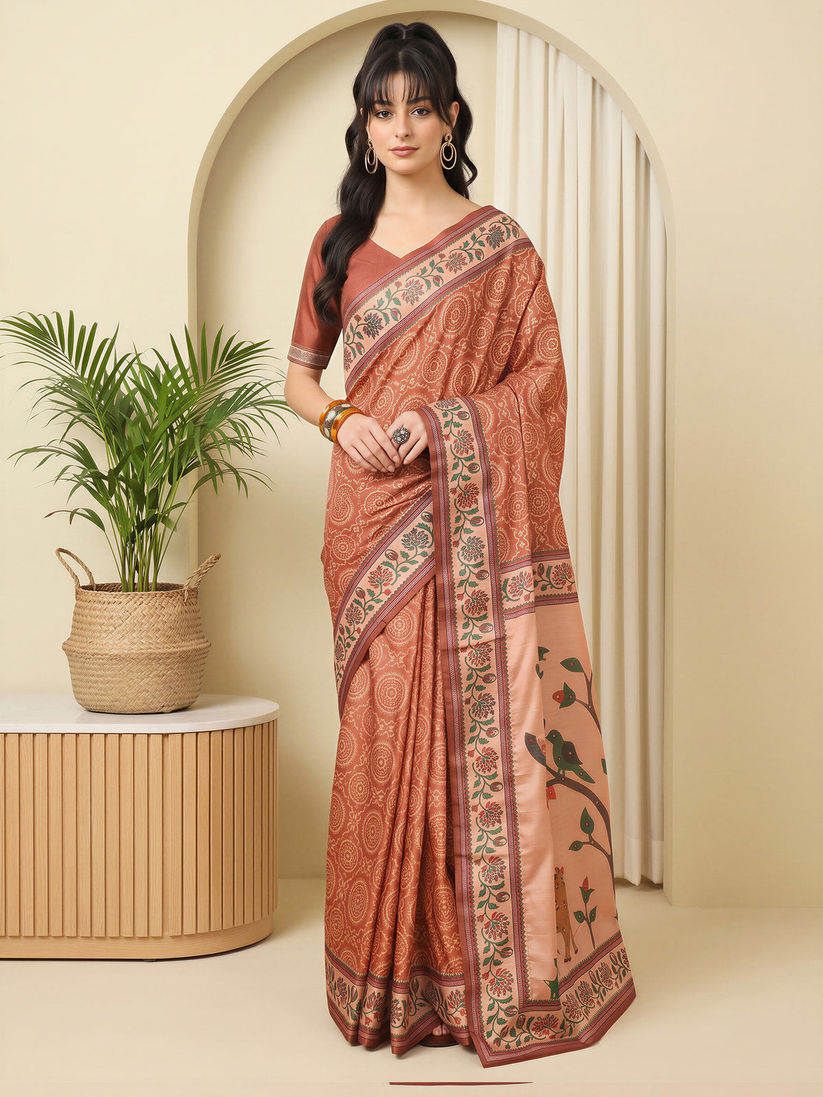 Woman wearing rust silk blend saree with traditional indian motif work and rust blouse