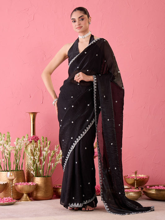 Woman wearing black paper silk ready to wear saree with embroidered motif work and black blouse