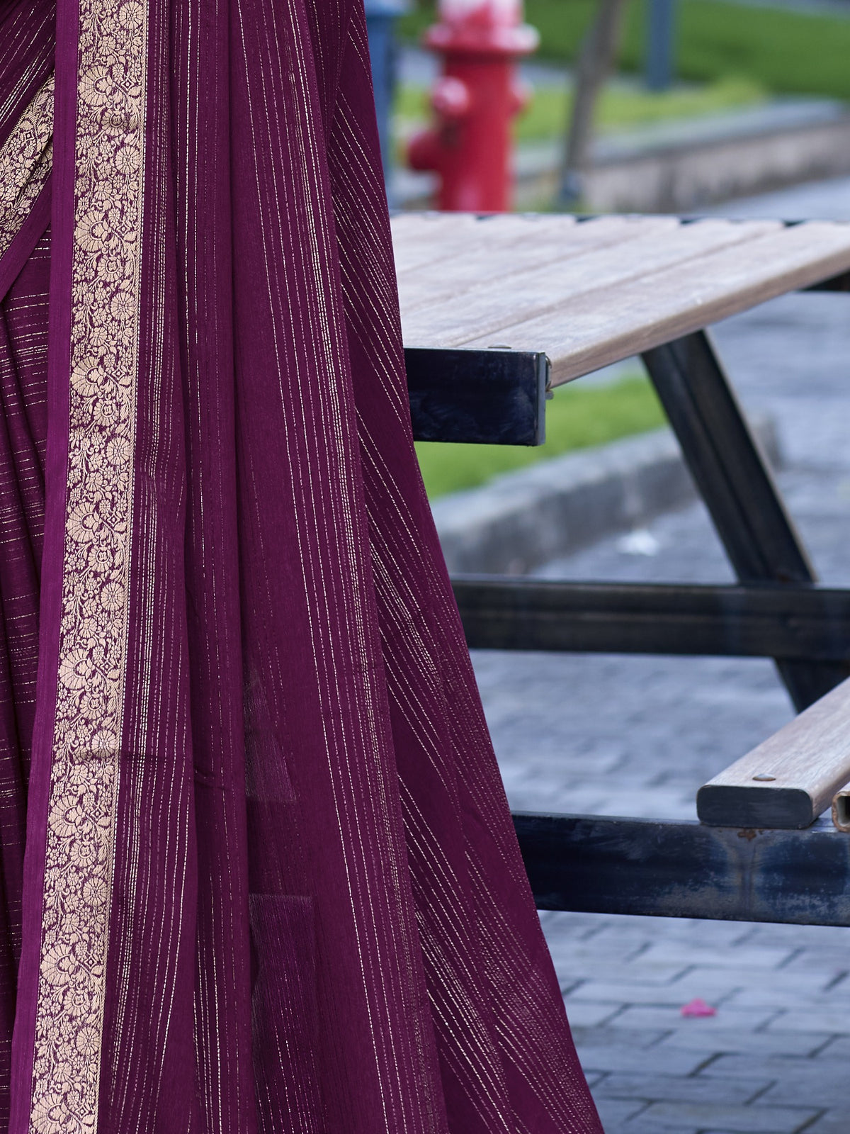 Pallu detail of wine jacquard saree showing striped pattern design and zari border