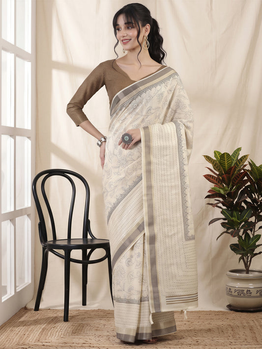 Woman wearing off white cotton silk saree with ornamented surface design and beige blouse