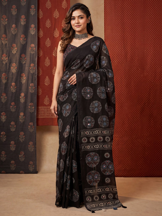 Woman wearing black linen saree with abstract contemporary design and black blouse