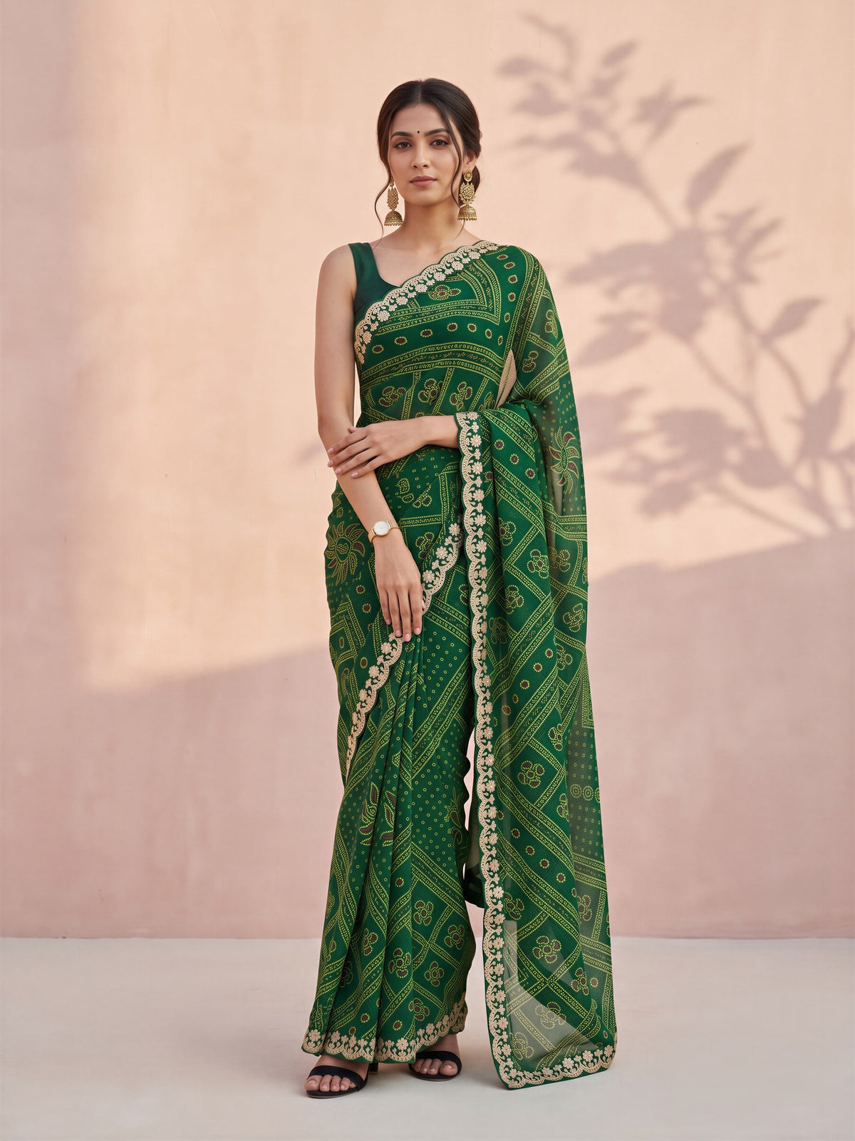 Woman wearing green georgette saree with bandhani tie-dye dot work and green blouse