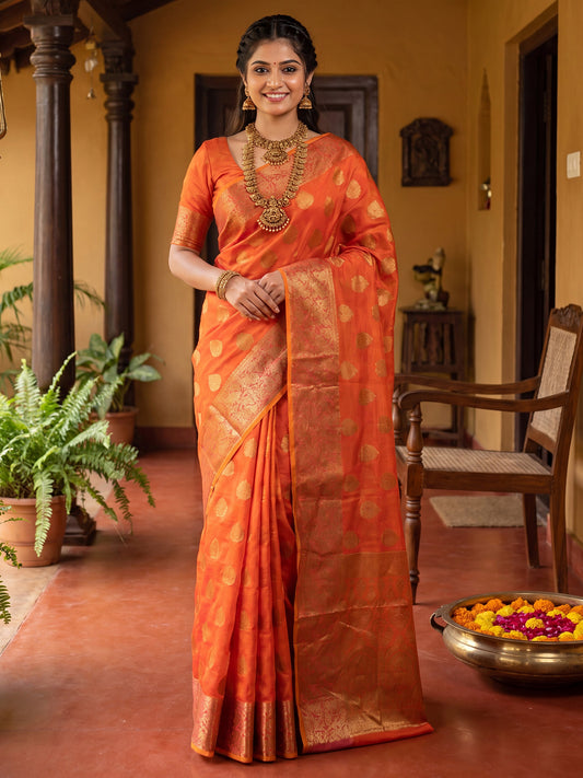 Woman wearing orange silk blend saree with zari butta (metallic motif) work and orange blouse