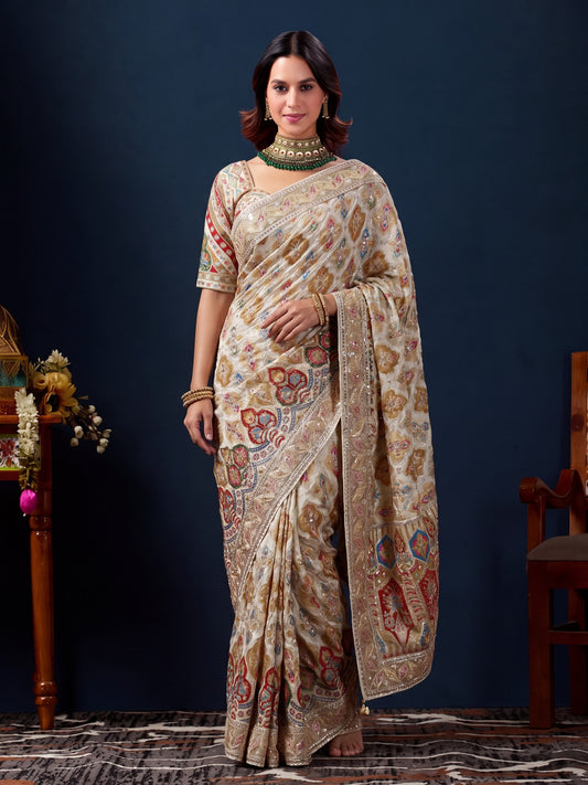 Woman wearing white silk blend saree with traditional indian motif work and white blouse