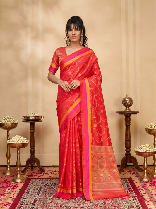 Woman wearing coral pure silk saree with traditional indian motif work and coral blouse