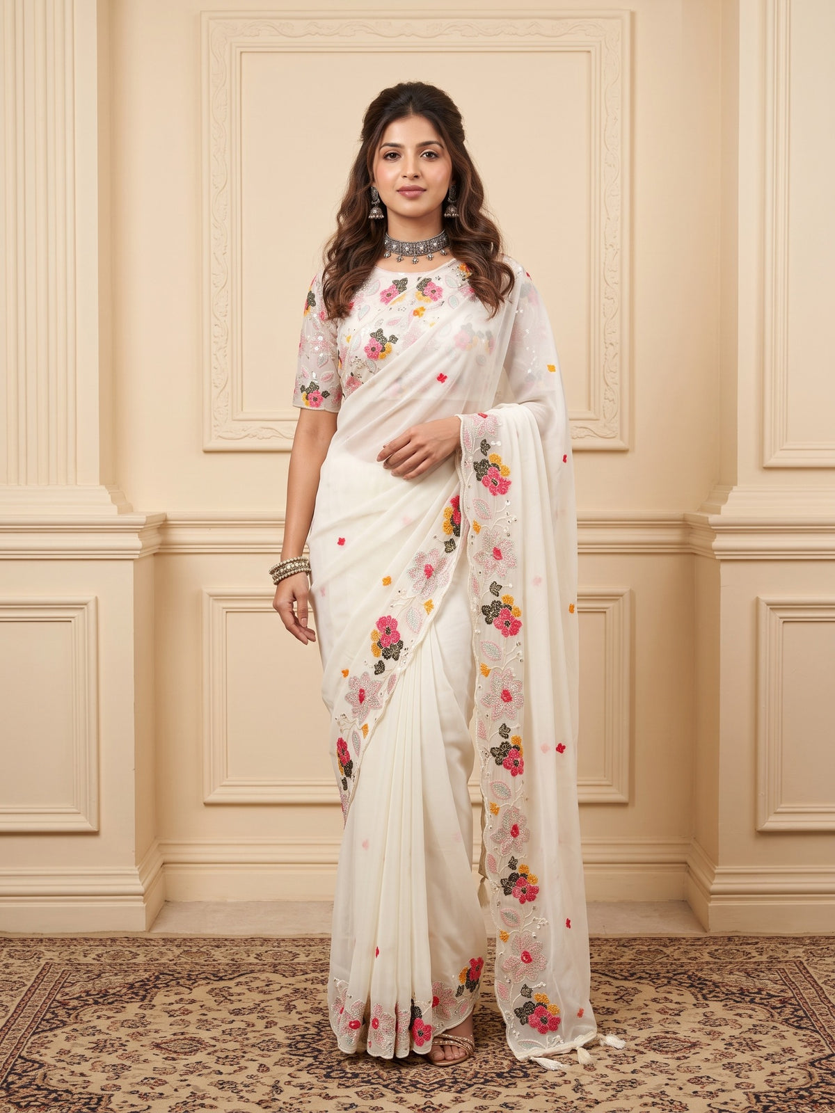 Woman wearing white georgette saree with embroidered motif work and white blouse