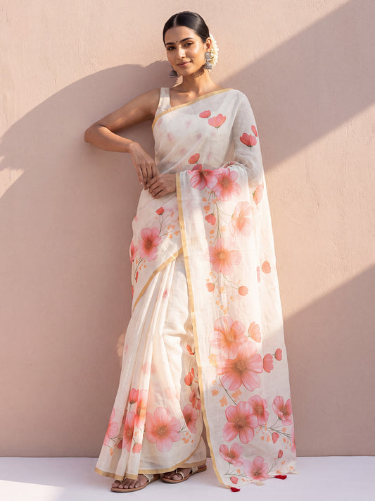 Woman wearing off white cotton linen saree with all-over floral design and off white blouse