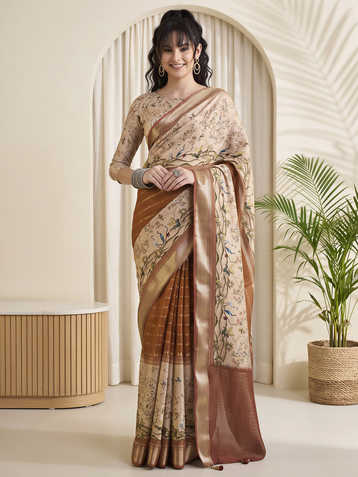 Woman wearing rust viscose silk saree with botanical floral and leaf design and beige blouse