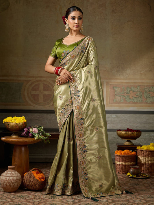 Woman wearing olive silk blend saree with ornamented surface design and olive blouse