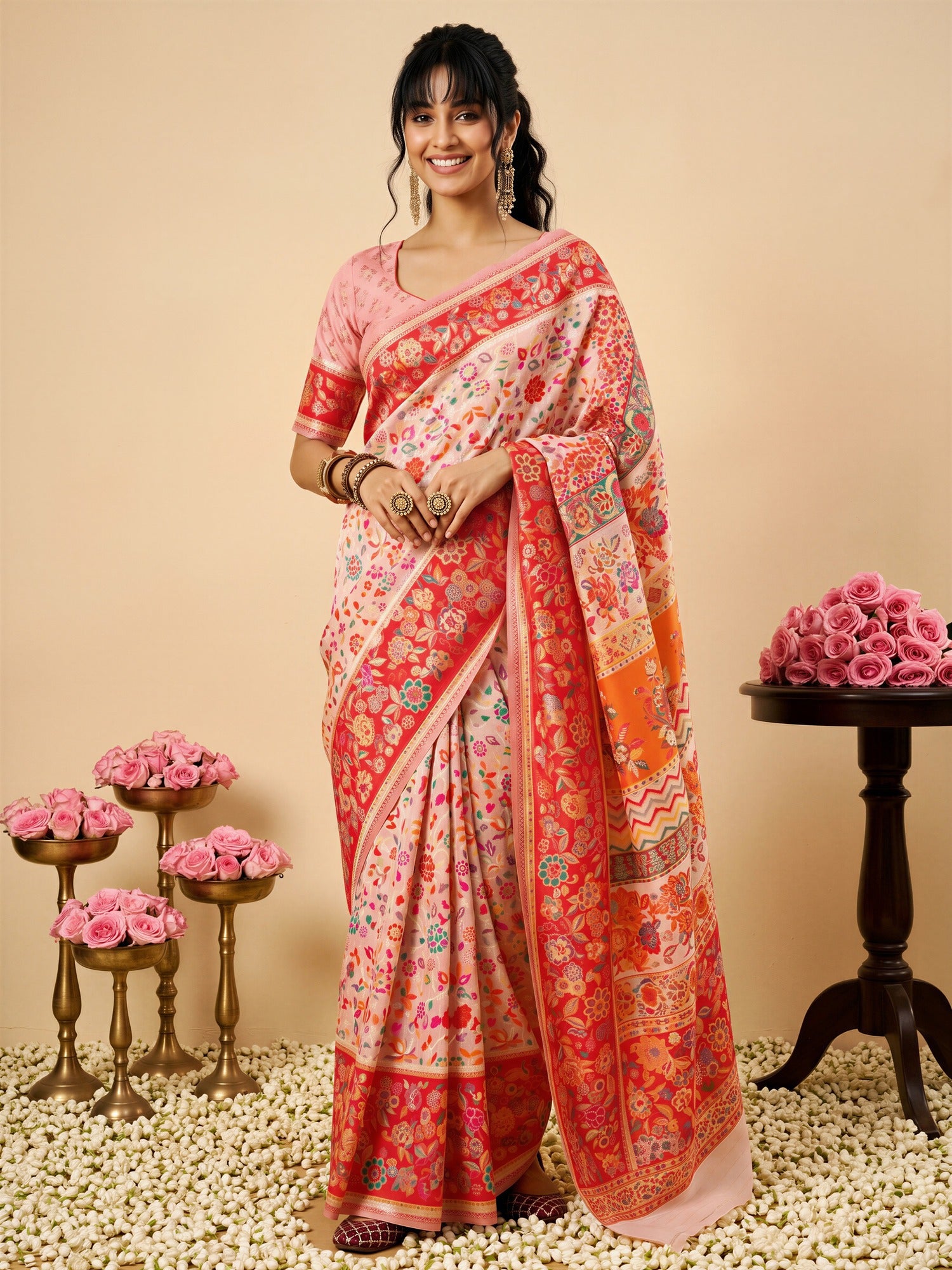Woman wearing pink cotton silk saree with all-over floral design and pink blouse