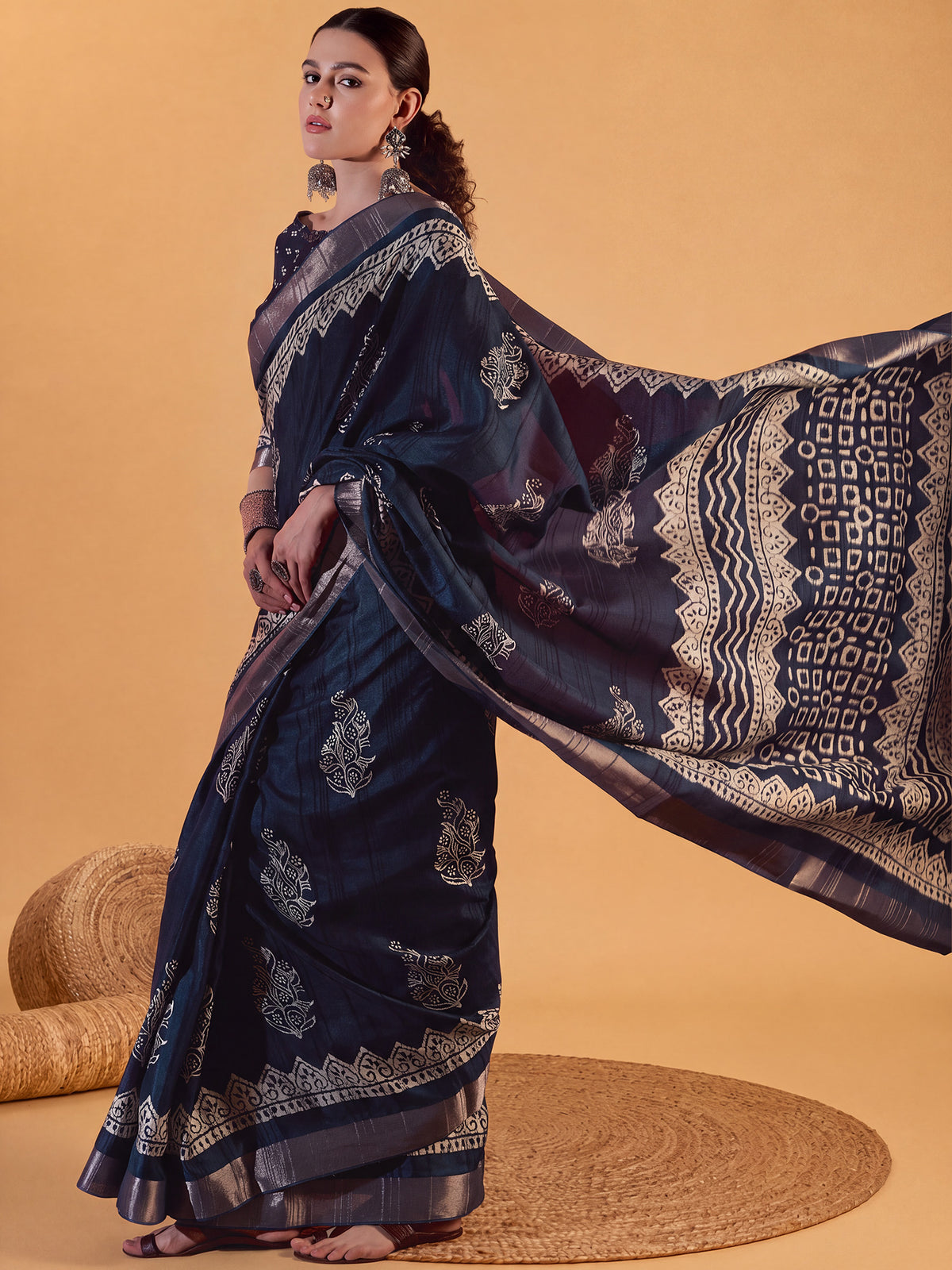 Woman wearing teal blue silk blend saree with dabu mud-resist print work and teal blue blouse