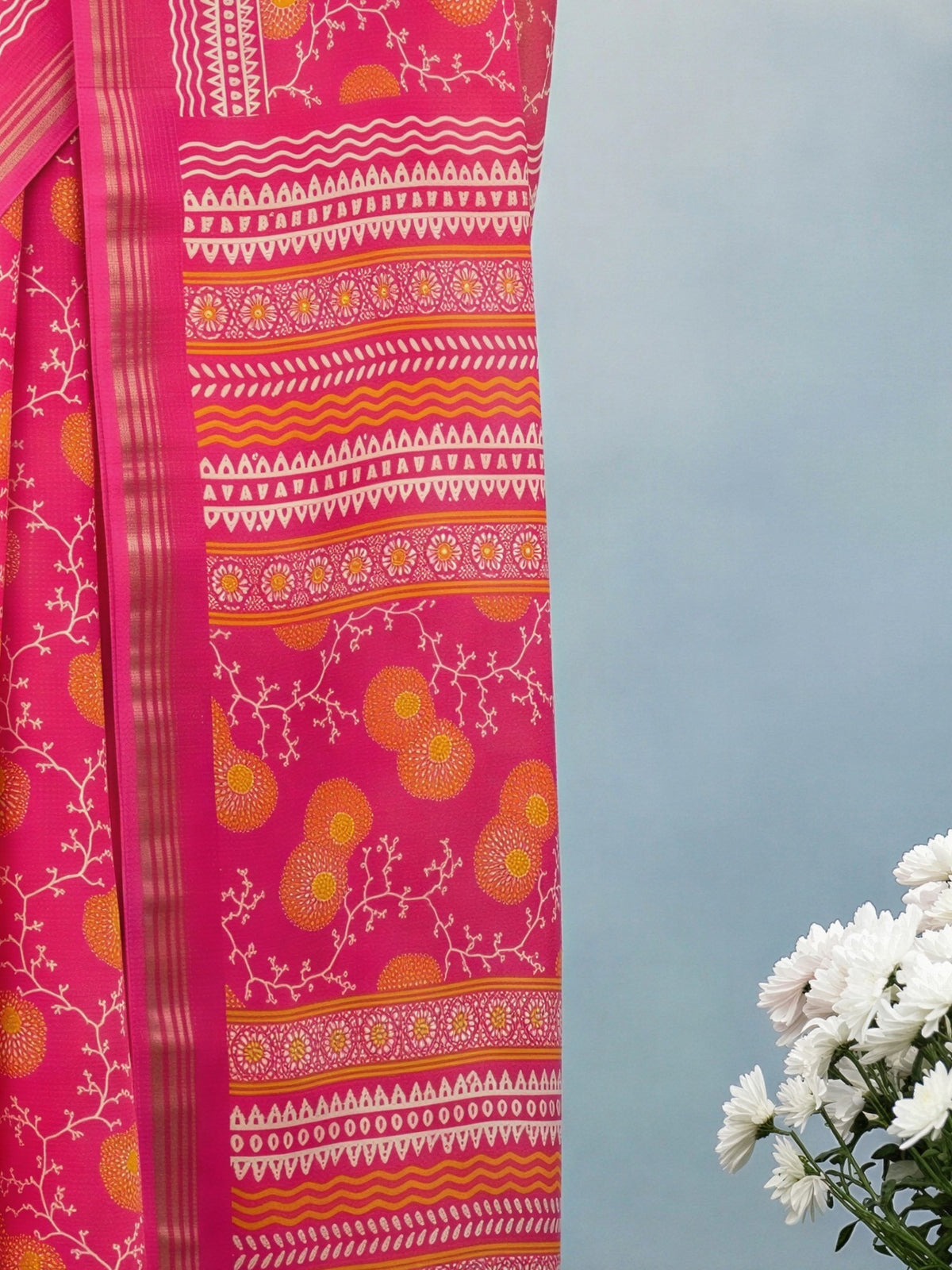 Pallu detail of pink crepe saree showing botanical floral and leaf design and zari border