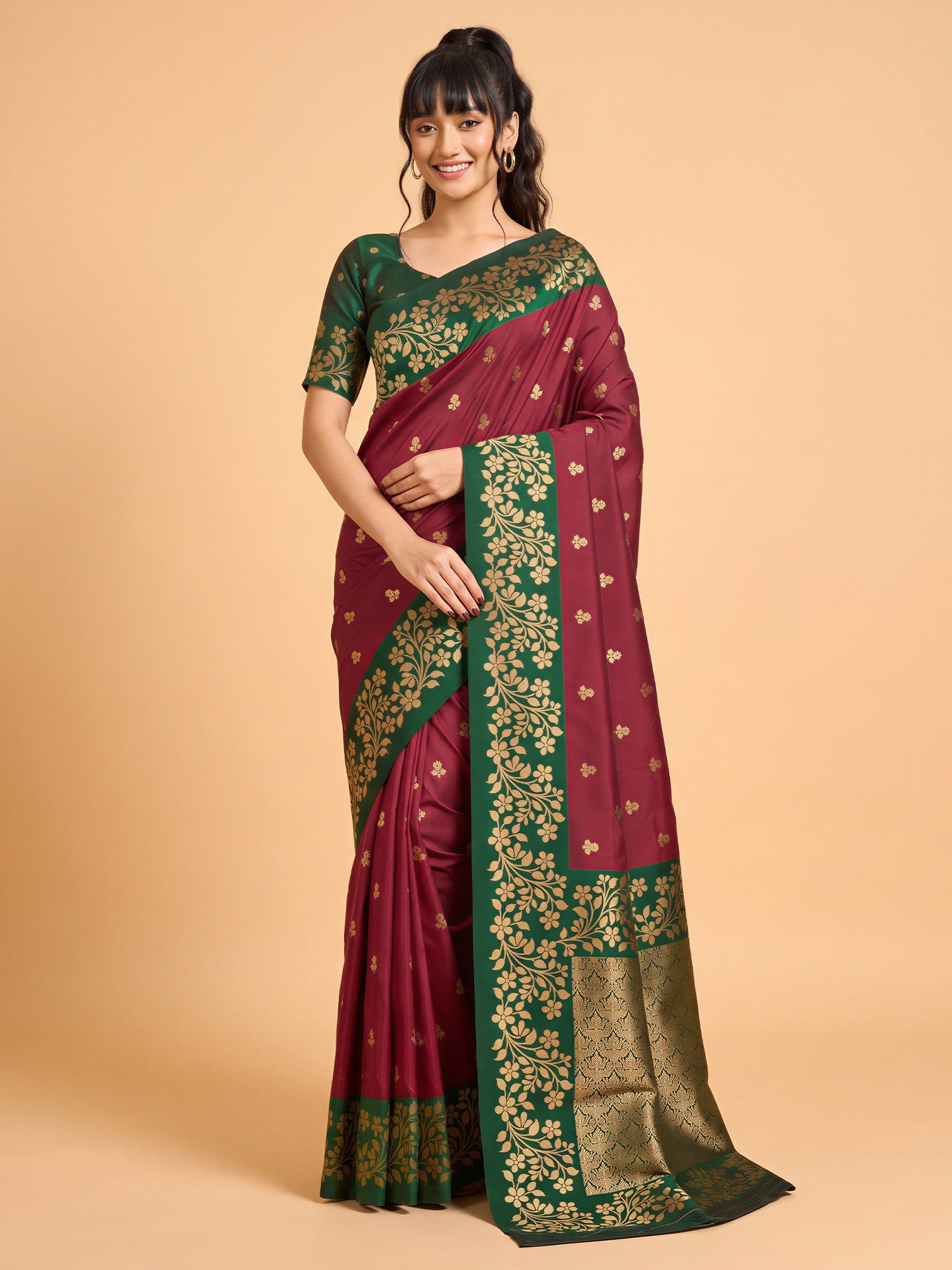 Woman wearing maroon cotton blend saree with all-over floral design and green blouse