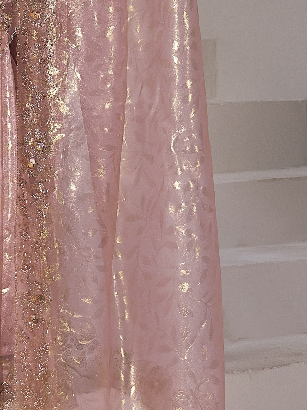 Pallu detail of pink organza saree showing applique design and scallop border
