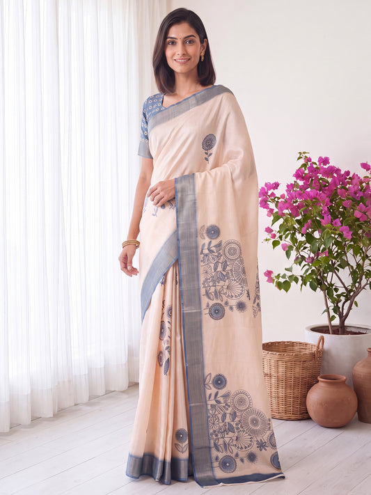 Woman wearing white satin silk saree with traditional indian motif work and light blue blouse