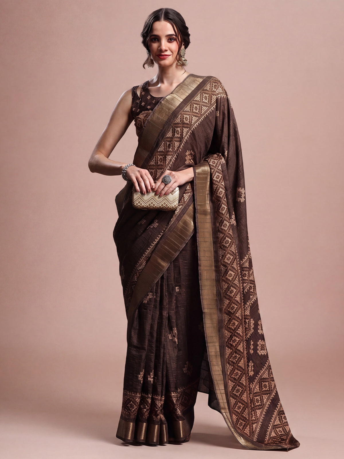 Woman wearing brown silk blend saree with geometric pattern design and brown blouse