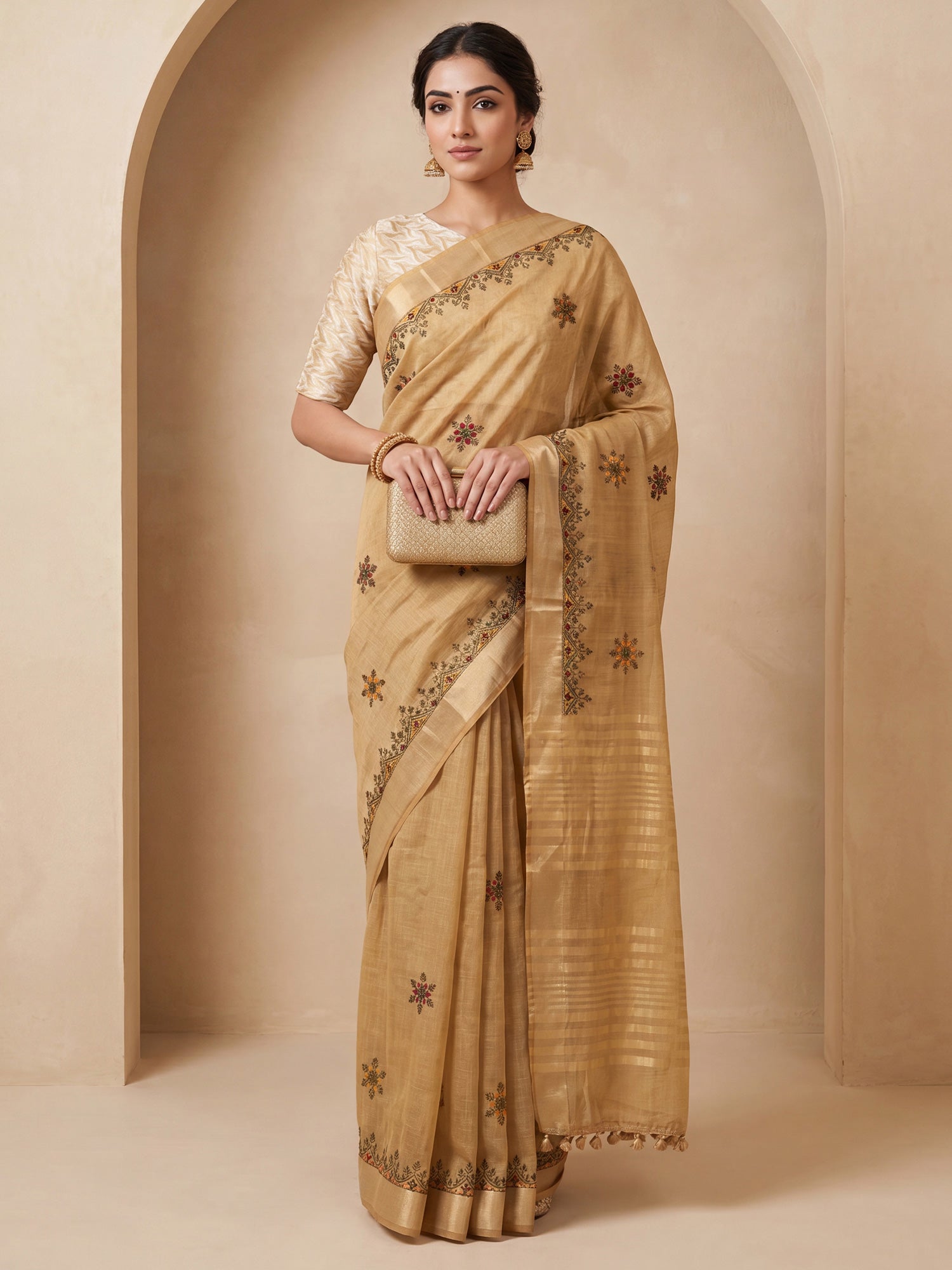 Woman wearing beige cotton linen saree with embroidered motif work and beige blouse