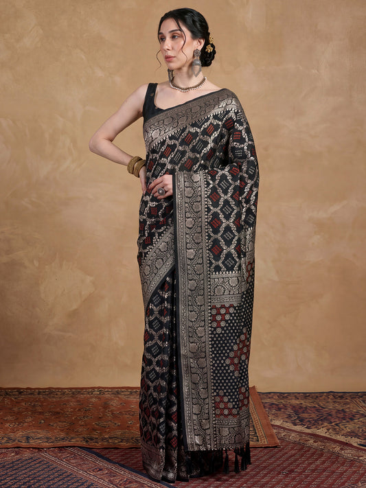 Woman wearing black dola silk saree with bandhani tie-dye dot work and black blouse