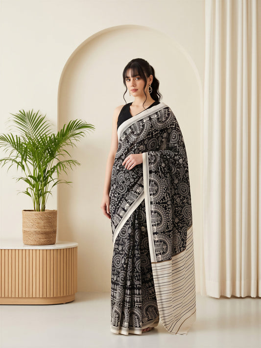 Woman wearing black bhagalpuri silk saree with warli folk-art figures and black blouse