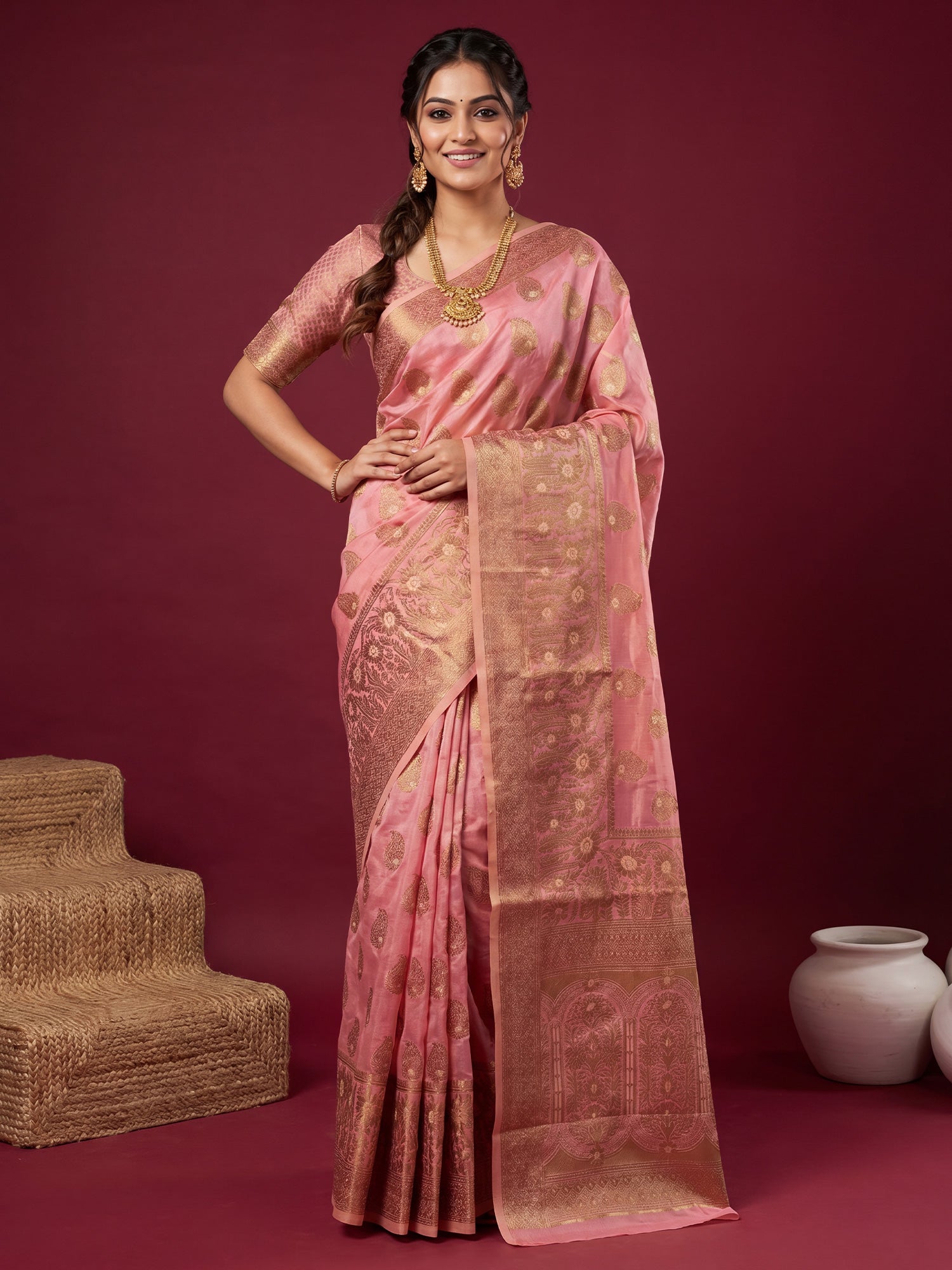 Woman wearing pink silk blend saree with zari butta (metallic motif) work and pink blouse