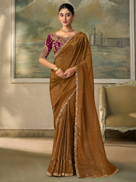 Woman wearing olive georgette saree with embroidered motif work and burgundy blouse