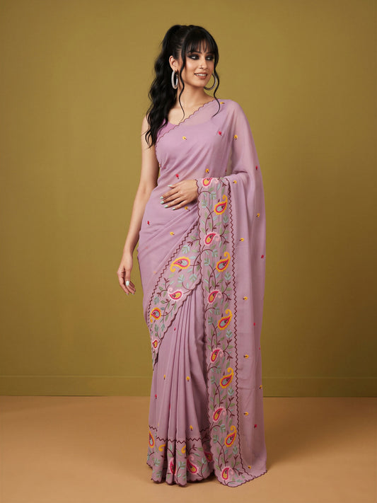 Woman wearing pink georgette saree with embroidered motif work and pink blouse