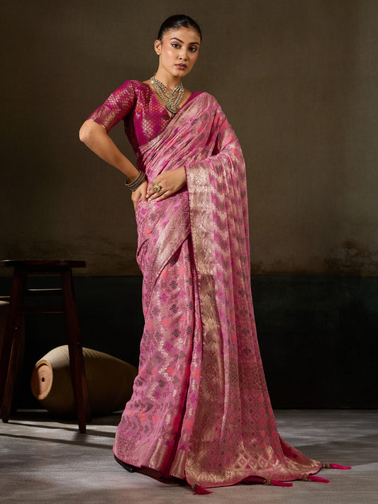Woman wearing pink georgette saree with woven motif design and magenta blouse