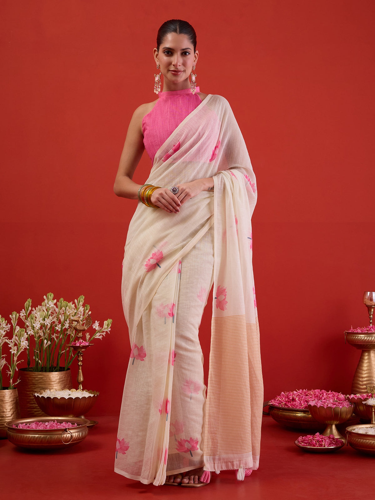 Woman wearing white chanderi cotton ready to wear saree with all-over floral design and pink blouse