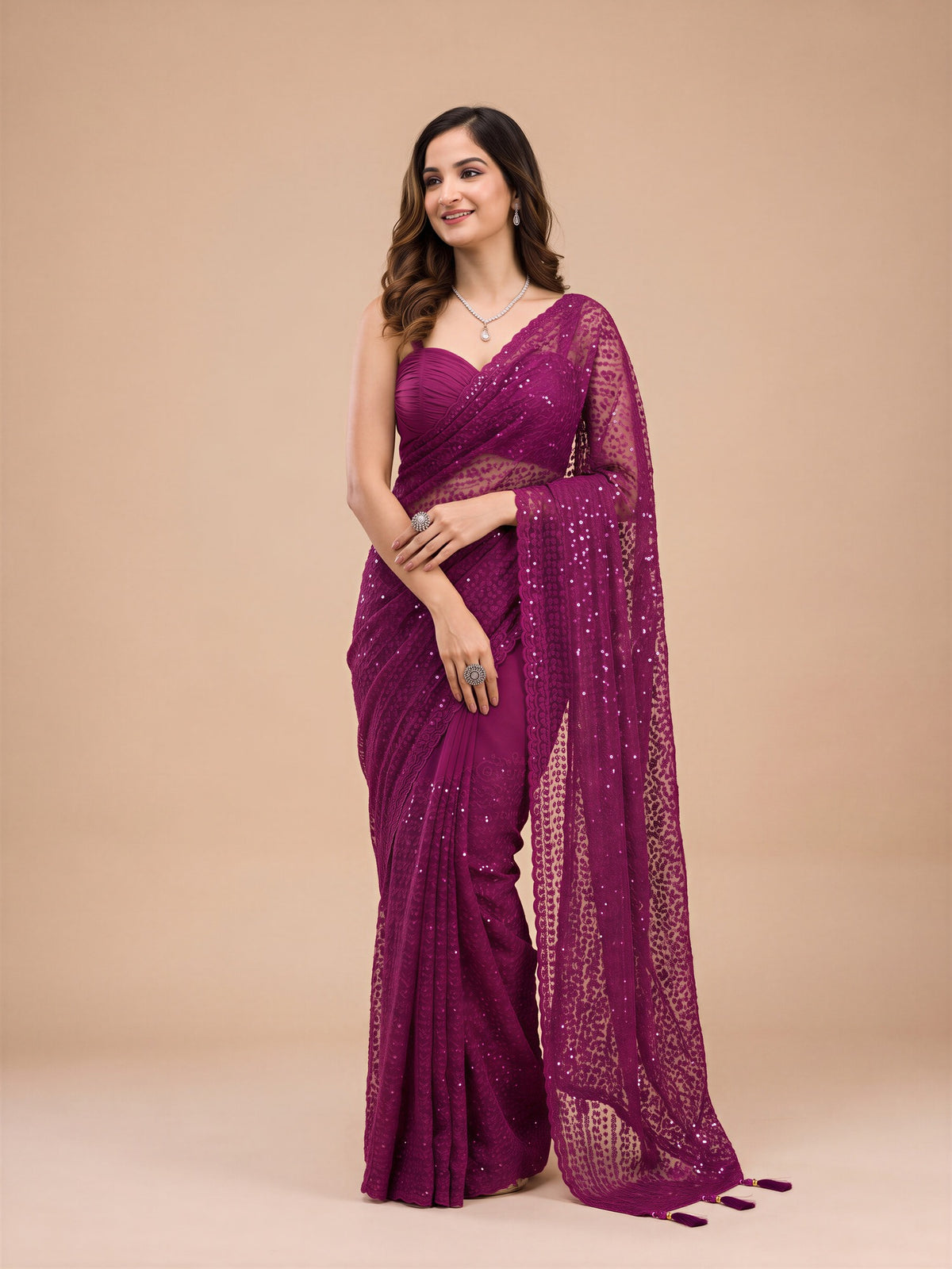 Woman wearing black net saree with embroidered motif work and black blouse
