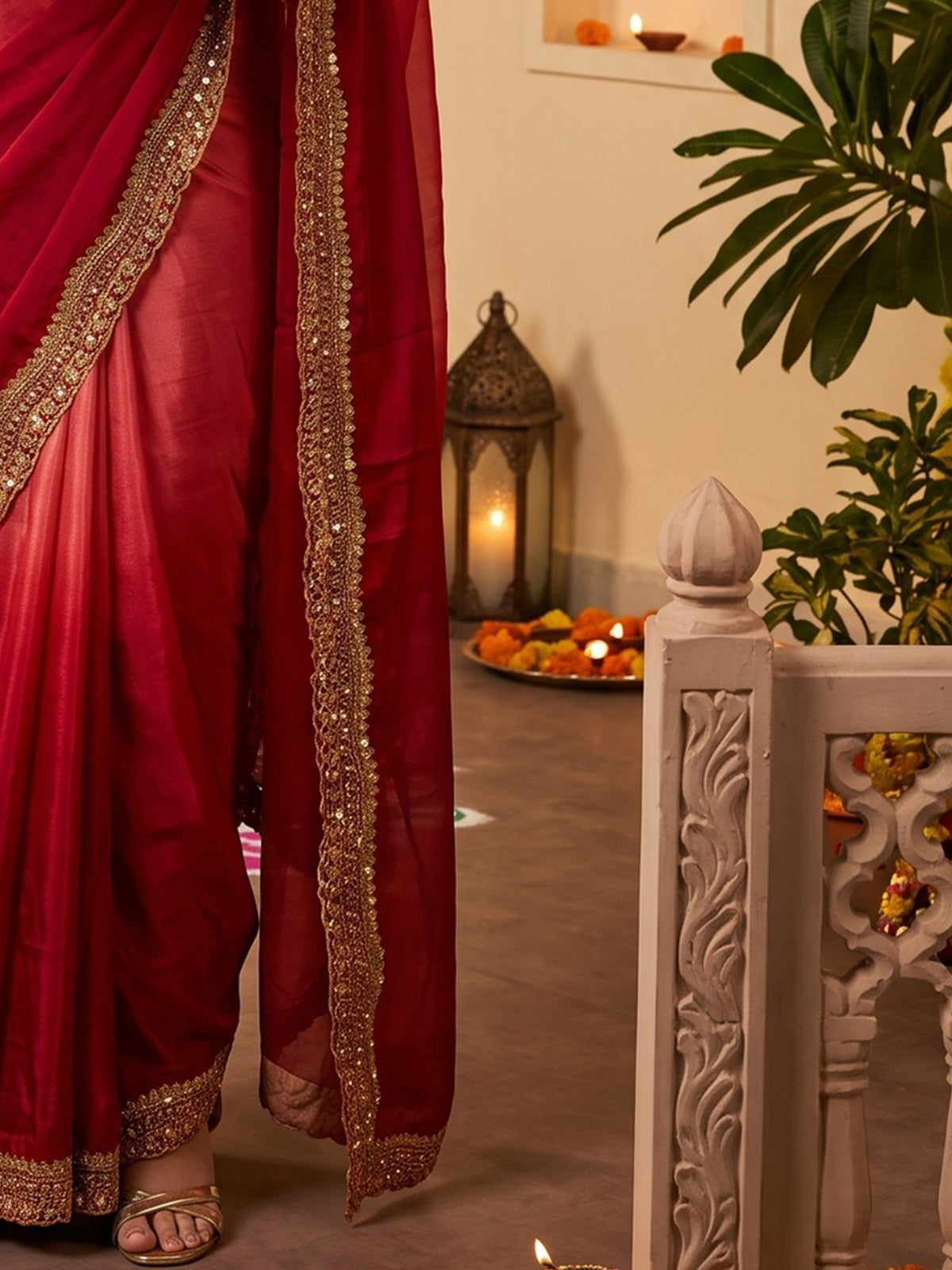 Pallu detail of red satin saree showing ombre graded colour work and embellished border