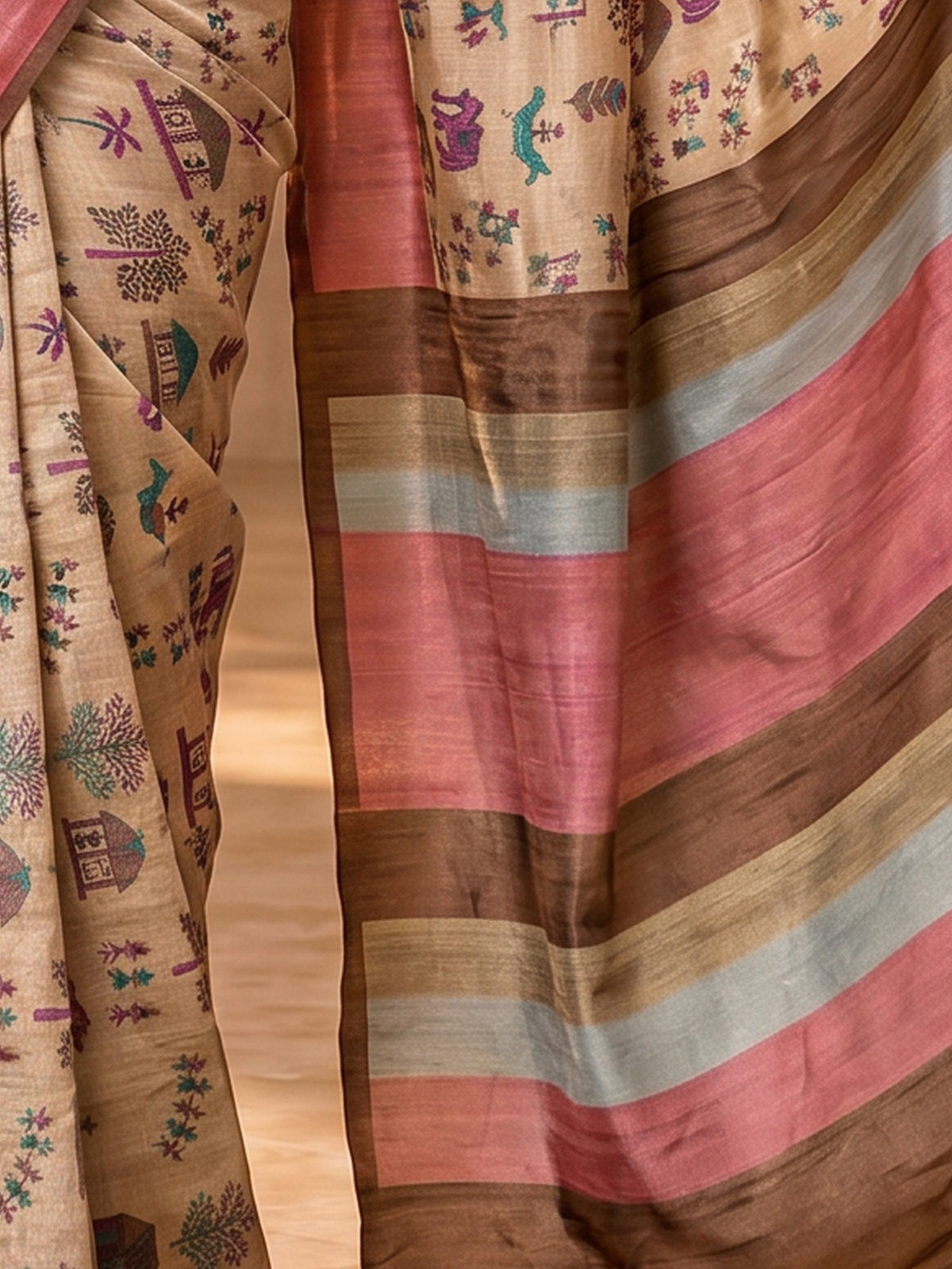 Pallu detail of beige soft silk saree showing tribal folk-art motifs and printed border
