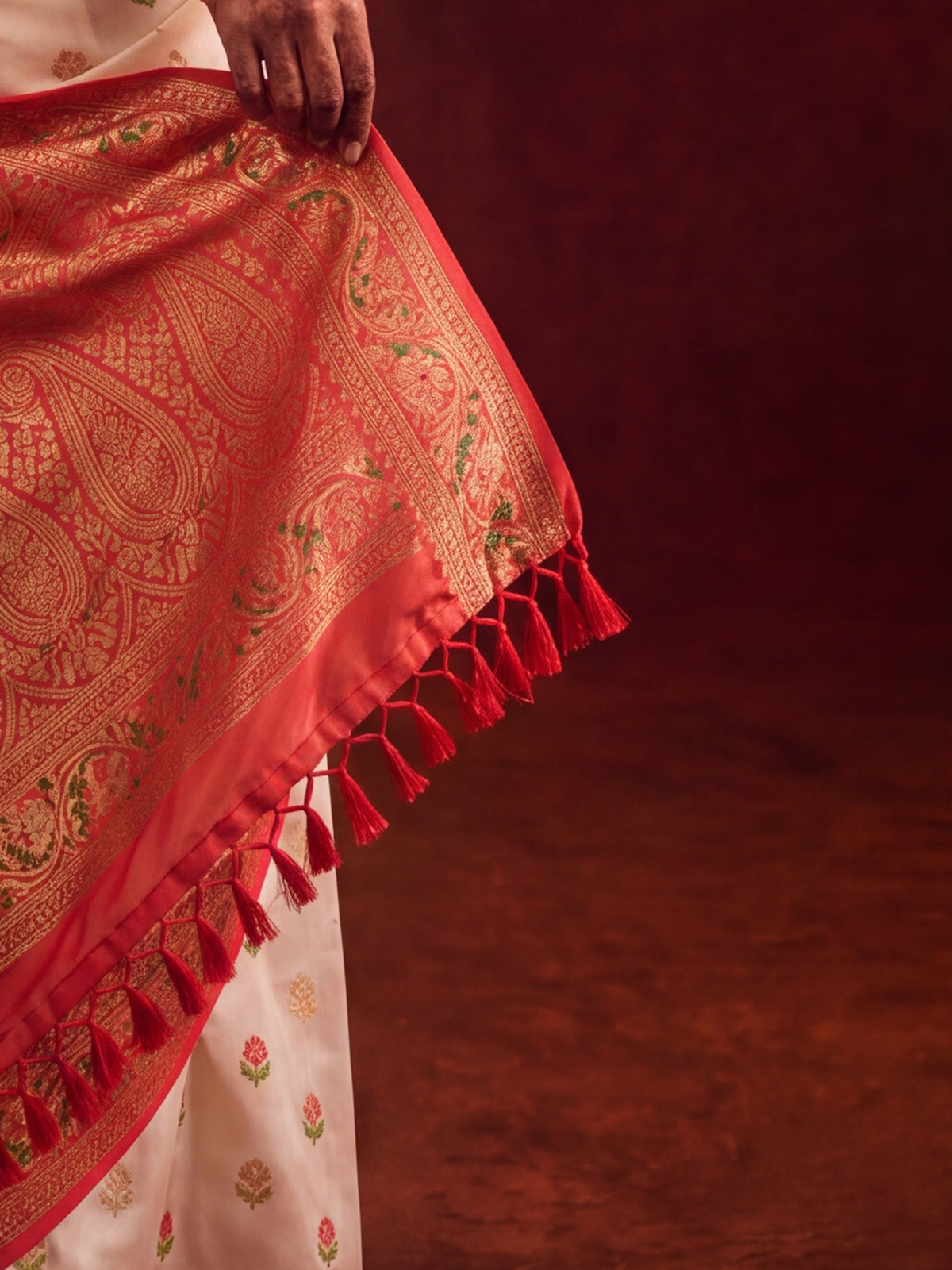 Pallu detail of white banarasi silk saree showing zari butta (metallic motif) work and zari border