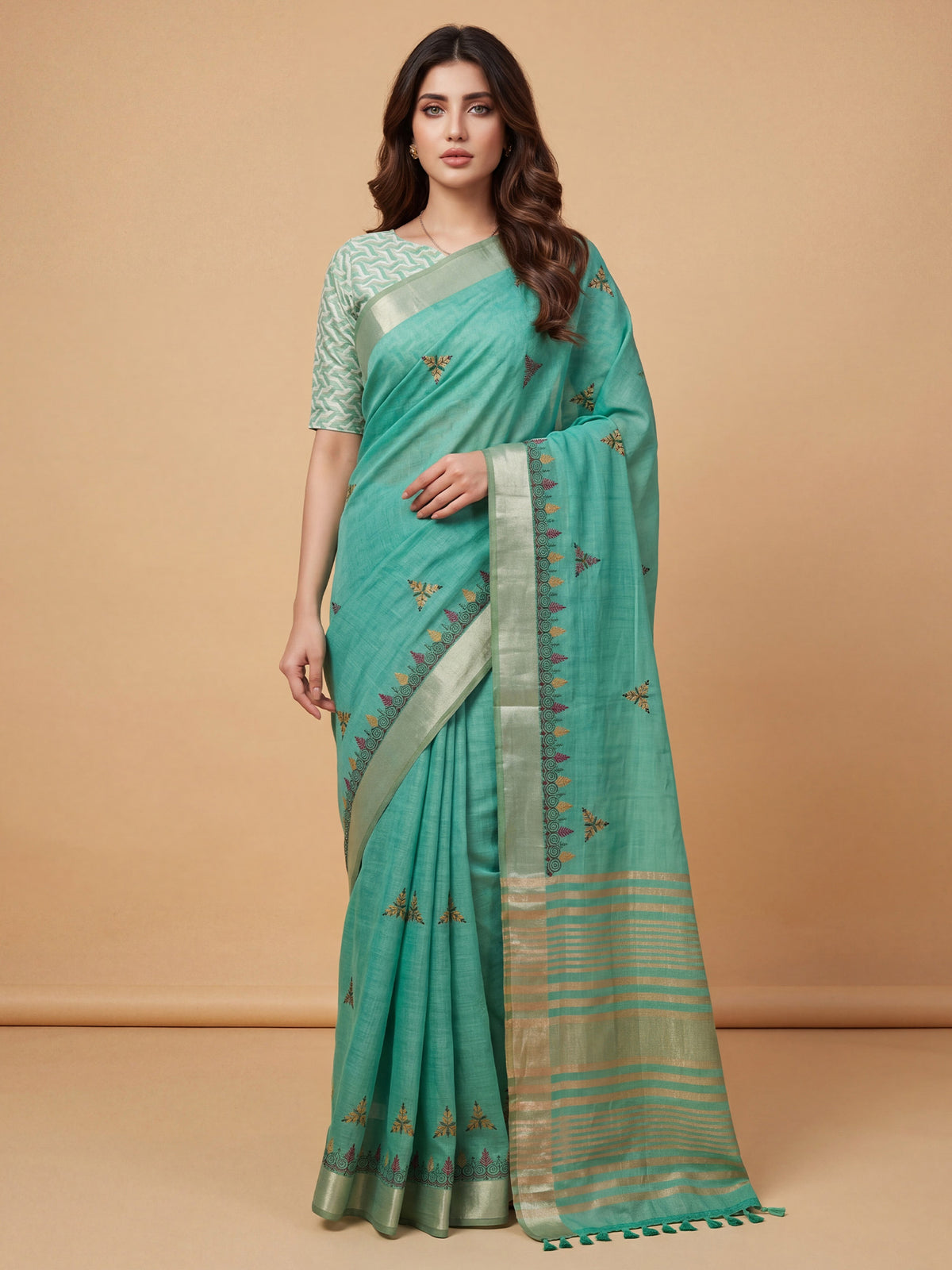Woman wearing sea green cotton linen saree with embroidered motif work and sea green blouse