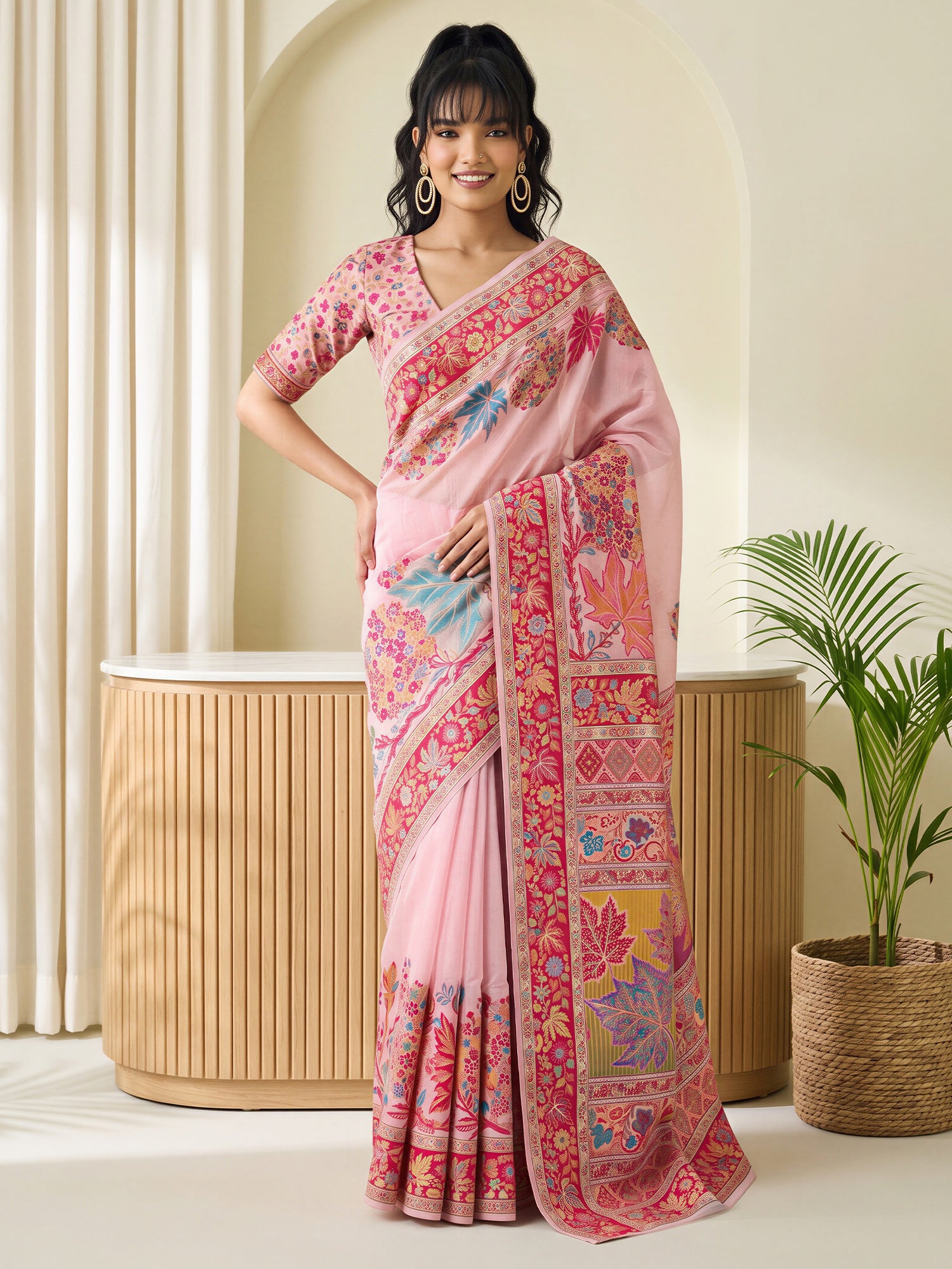 Woman wearing pink pashmina silk saree with traditional indian motif work and pink blouse