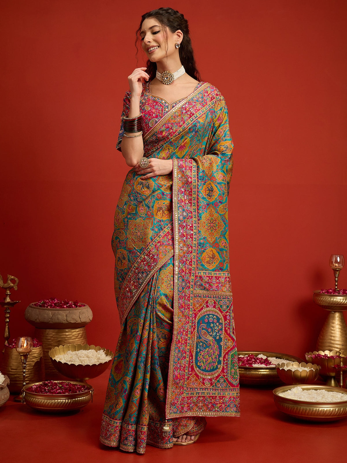 Woman wearing aqua blue silk blend saree with traditional indian motif work and pink blouse