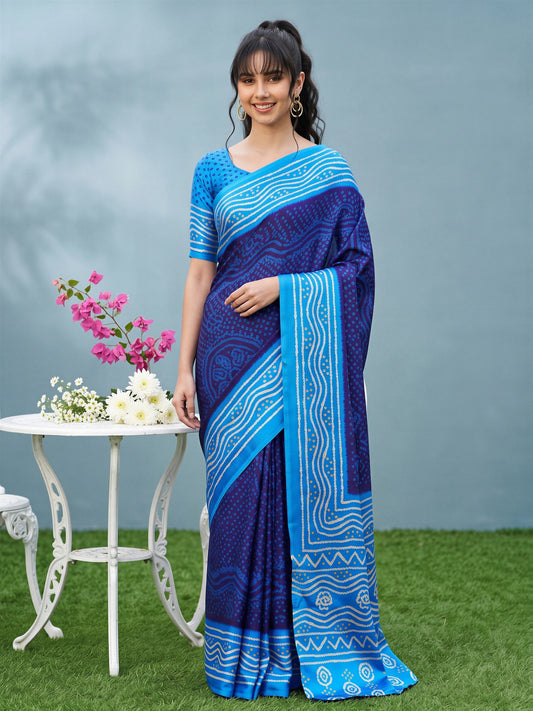 Woman wearing navy blue satin silk saree with bandhani tie-dye dot work and light blue blouse