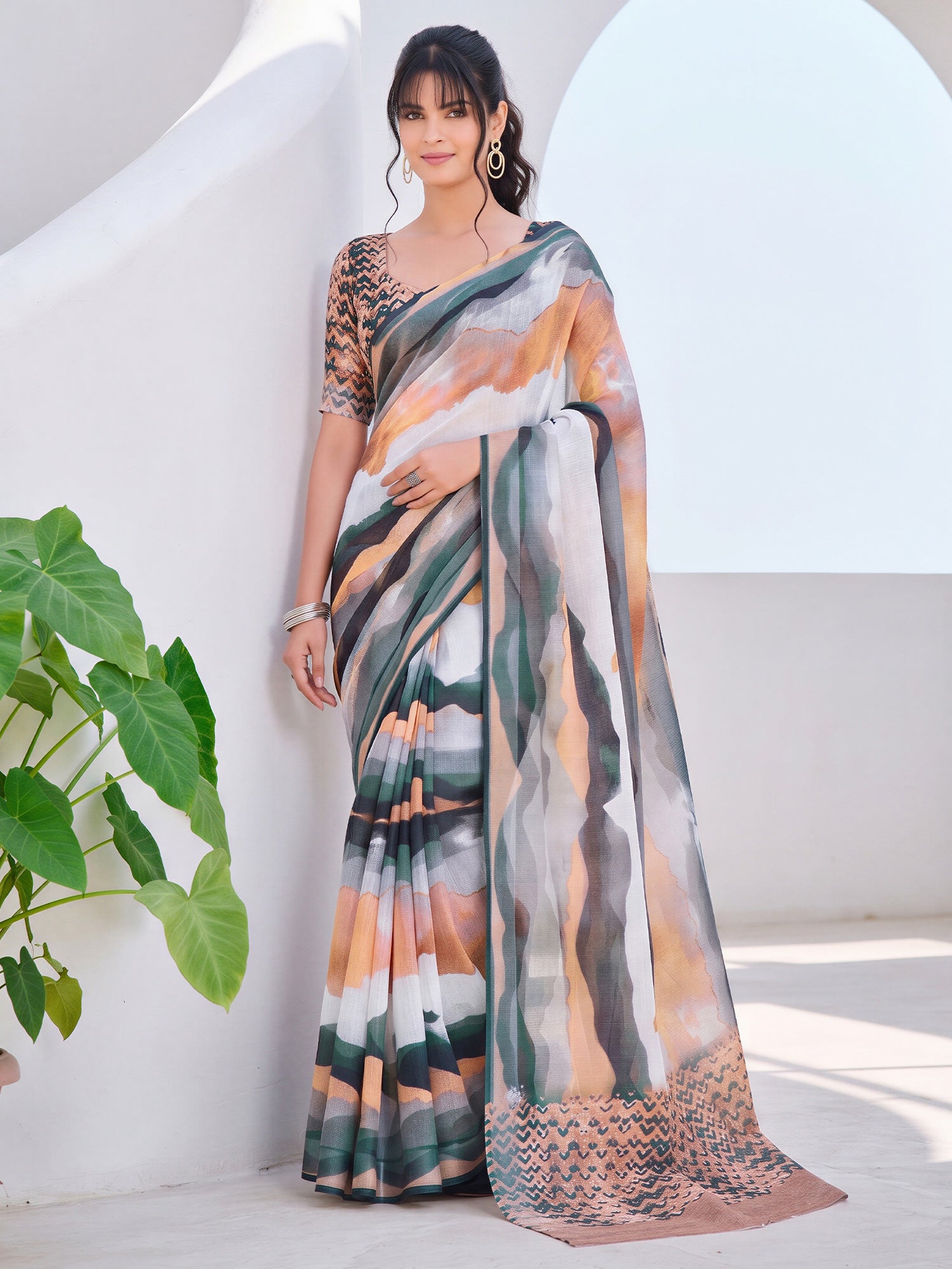 Woman wearing rust cotton linen saree with abstract contemporary design and rust blouse