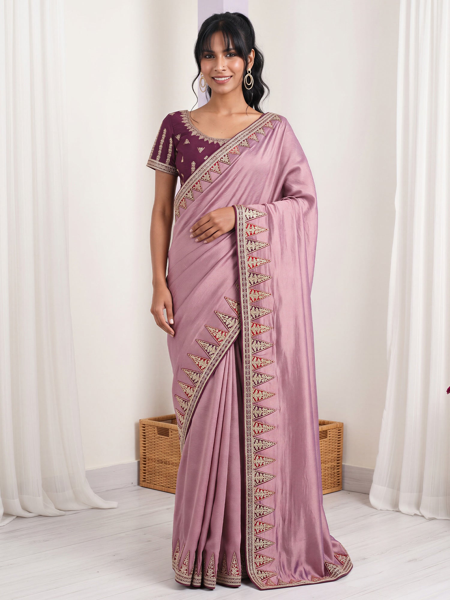 Woman wearing lavender vichitra silk saree with embroidered motif work and purple blouse