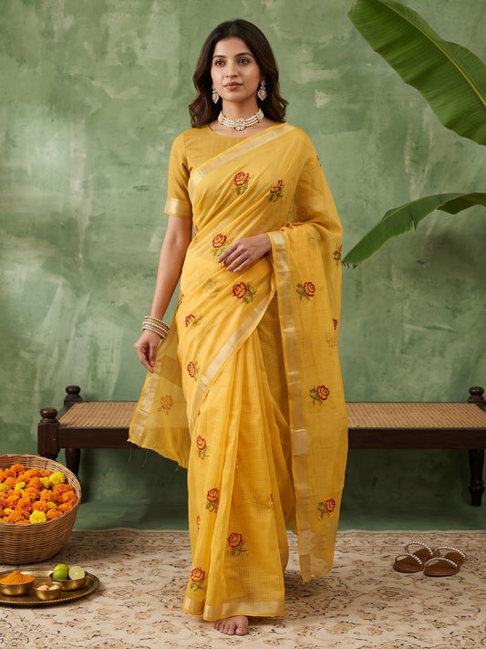 Woman wearing yellow kota doria cotton saree with embroidered motif work and yellow blouse