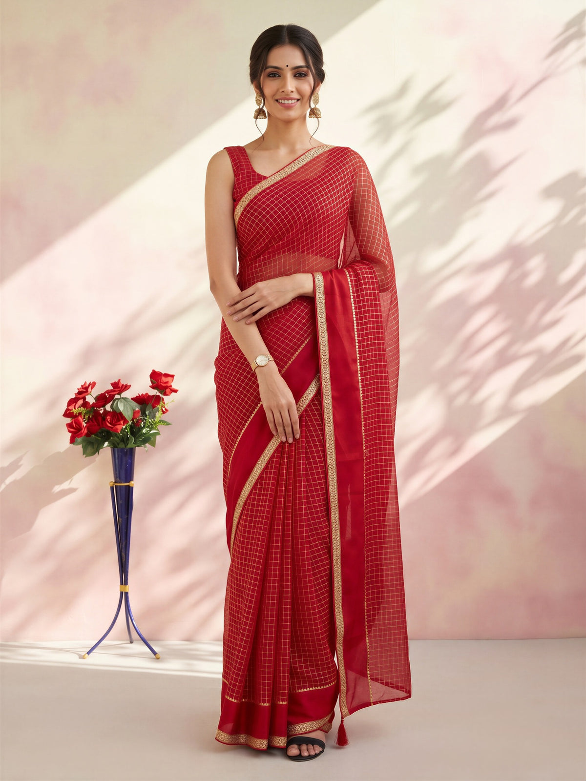 Woman wearing red viscose saree with checked pattern design and red blouse