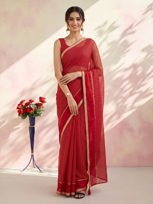 Woman wearing red viscose saree with checked pattern design and red blouse