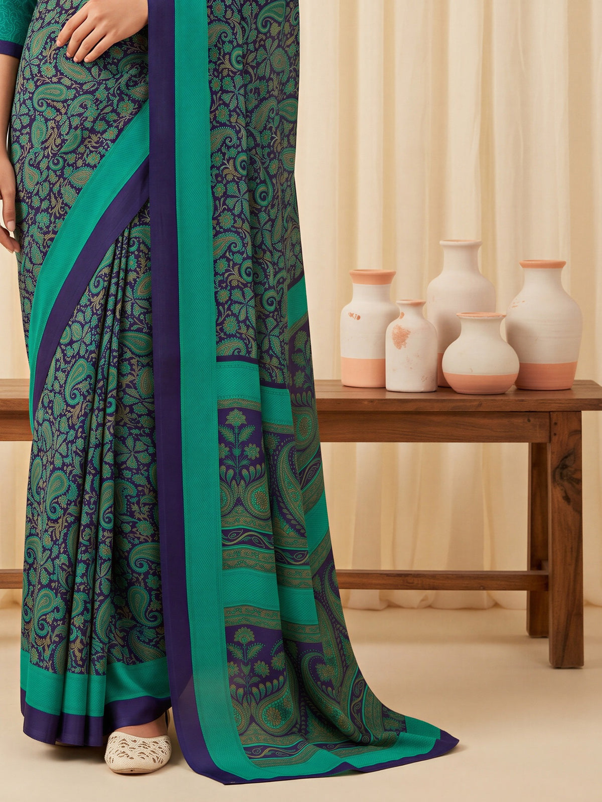 Pallu detail of teal green crepe saree showing bagh block-print motif work and printed border