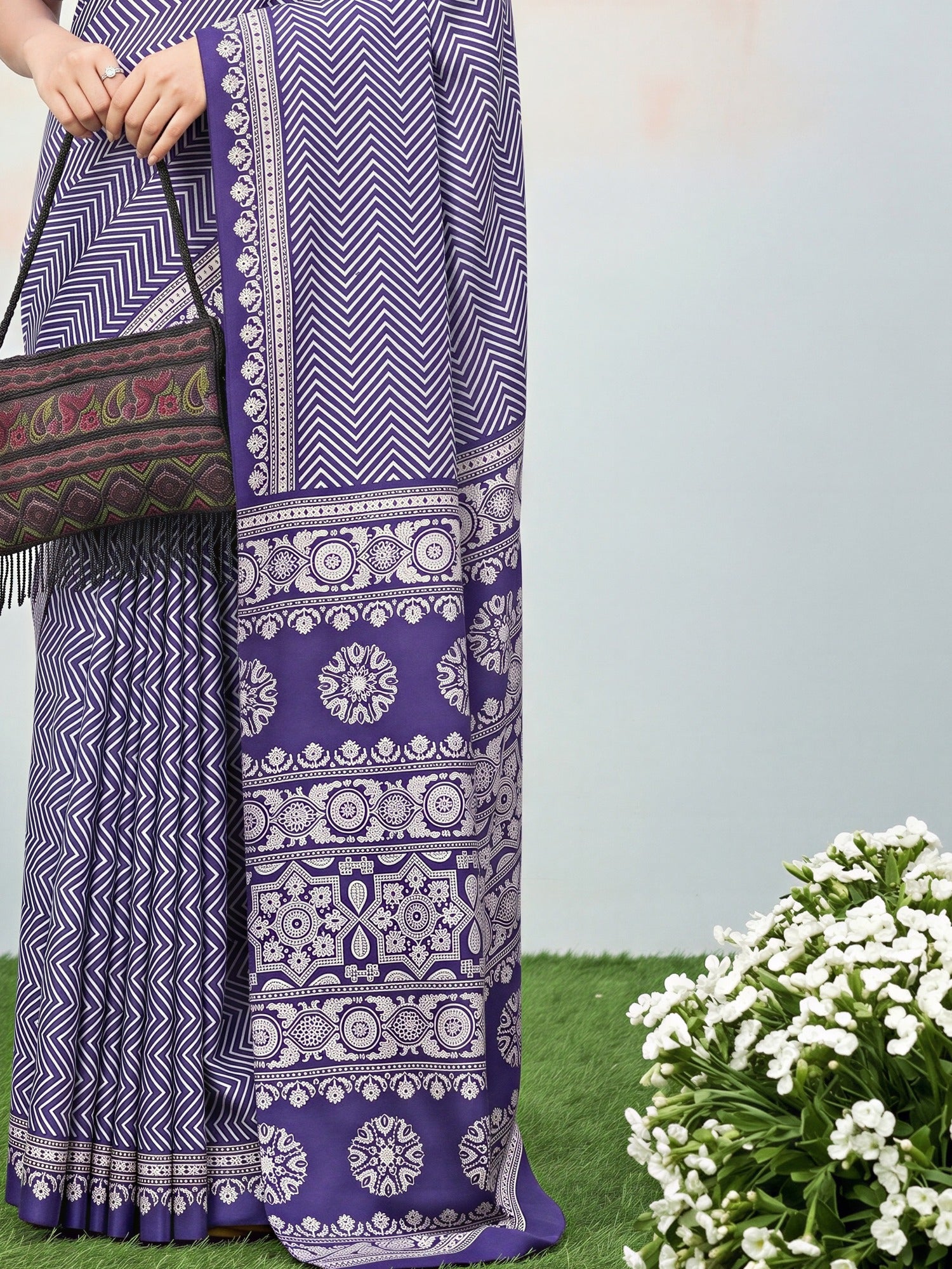 Pallu detail of purple dola silk saree showing ajrak block-print motif work and printed border